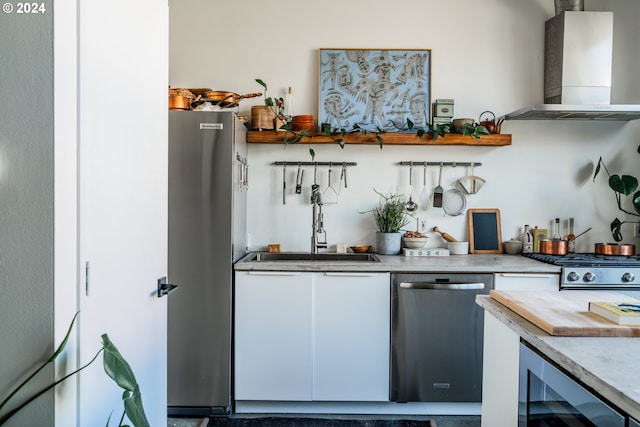 bar featuring appliances with stainless steel finishes, sink, beverage cooler, and range hood