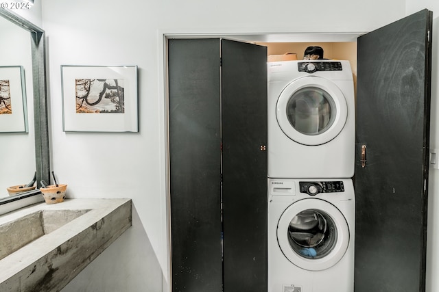 clothes washing area featuring stacked washer / drying machine