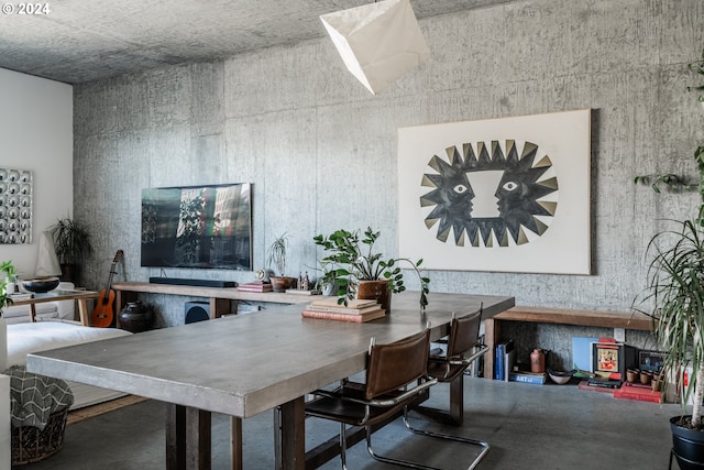 dining area featuring concrete flooring