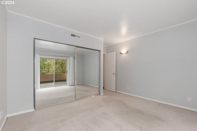 6605 W Burnside Rd Unit 144, Portland, OR 97210 - unfurnished bedroom with carpet, baseboards, crown molding, access to exterior, and a closet