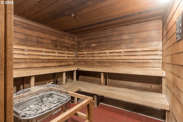 view of sauna with wooden walls and wooden ceiling