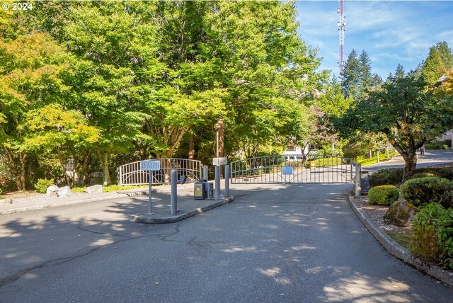 6605 W Burnside Rd Unit 144, Portland, OR 97210 - view of asphalt street with a gate, curbs, and a gated entry