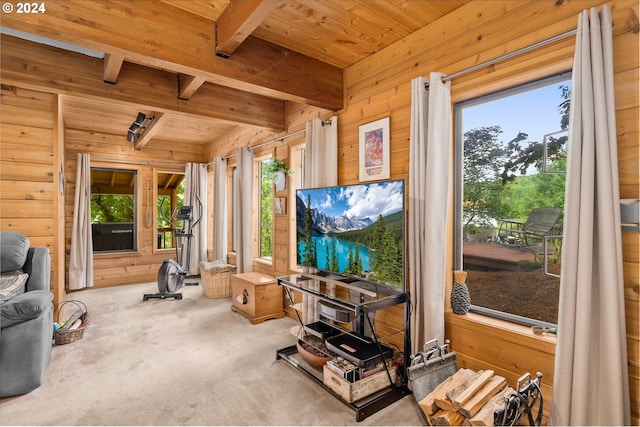 living room with beamed ceiling, wooden walls, carpet flooring, and wood ceiling