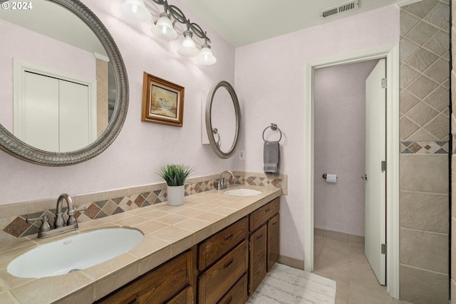 bathroom featuring dual bowl vanity and tile patterned flooring