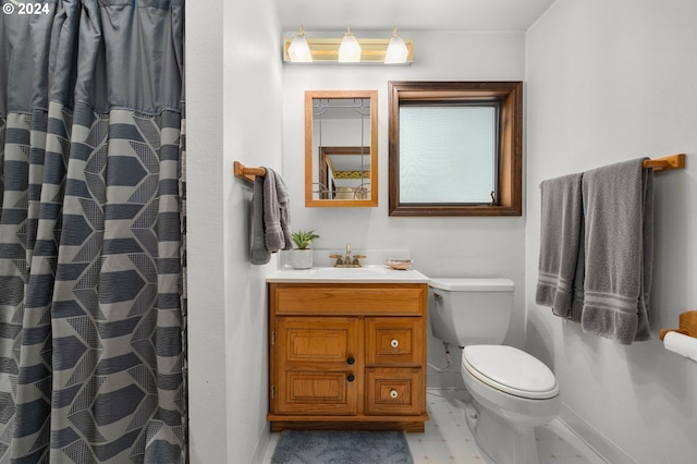 bathroom featuring tile patterned floors, vanity, and toilet