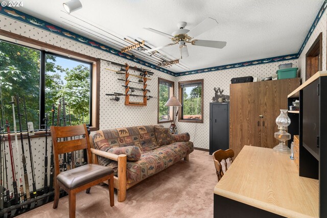 living room with ceiling fan, a textured ceiling, and carpet