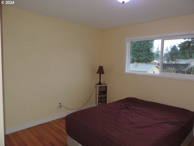 bedroom with wood-type flooring