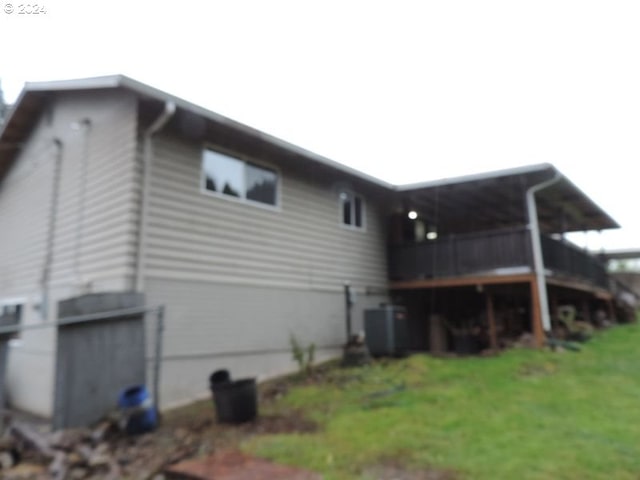 view of side of property with a lawn and cooling unit