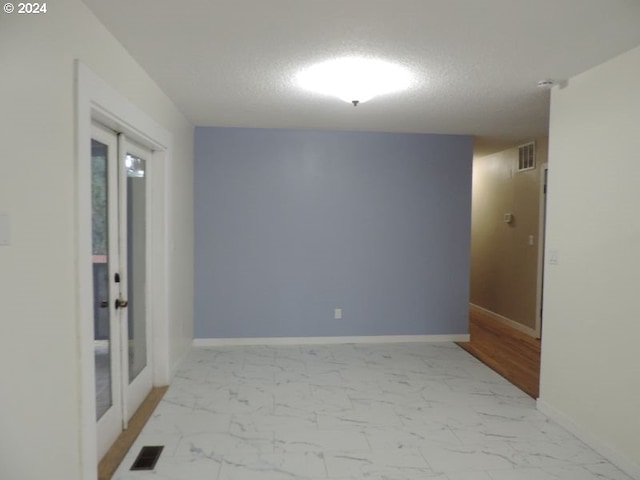 empty room with a textured ceiling