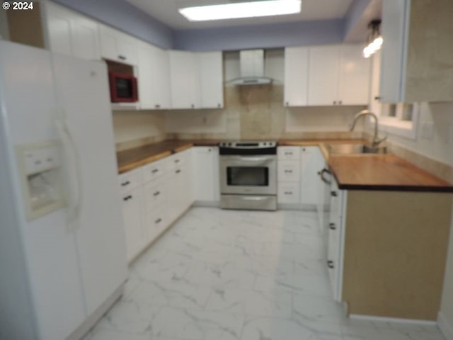 kitchen with wall chimney exhaust hood, sink, white cabinets, range, and white fridge with ice dispenser