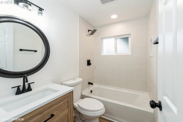 full bathroom with vanity, toilet, and tiled shower / bath