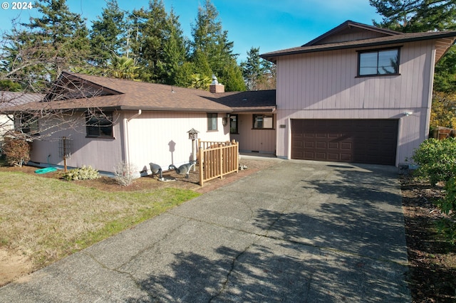 view of front of home featuring a garage and a front lawn