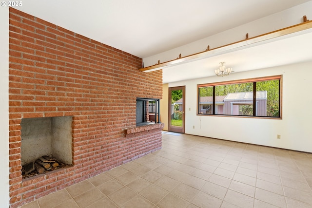 unfurnished living room with tile patterned floors, baseboards, an inviting chandelier, brick wall, and a fireplace