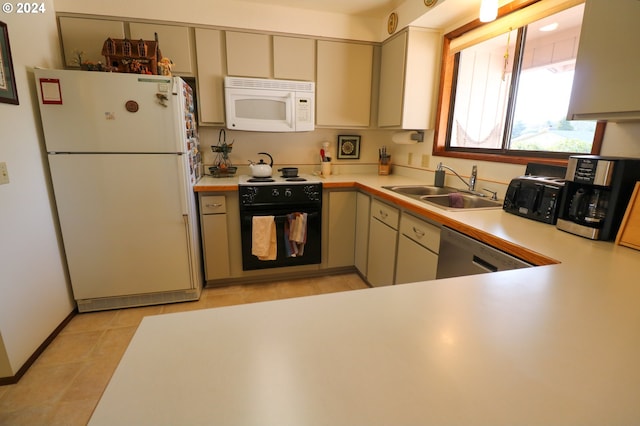 kitchen featuring black appliances, light tile patterned floors, and sink