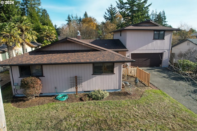 view of home's exterior featuring a garage and a lawn