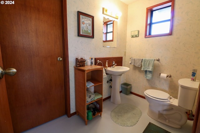 bathroom with a wealth of natural light and toilet