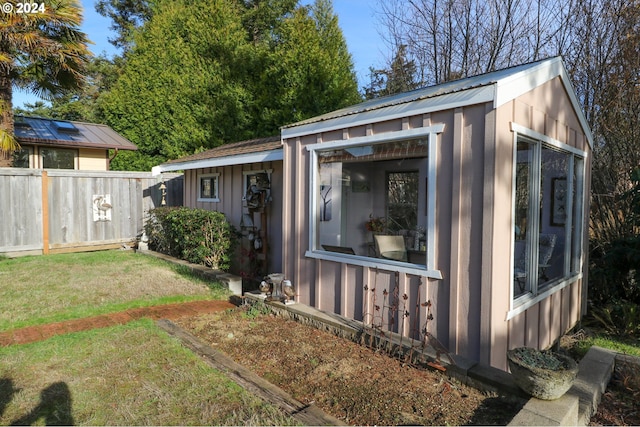 view of outbuilding featuring a yard