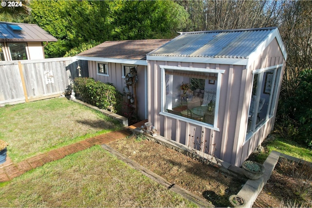 view of outdoor structure featuring a lawn