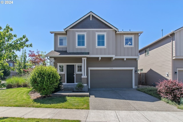 craftsman-style house featuring a front yard and a garage