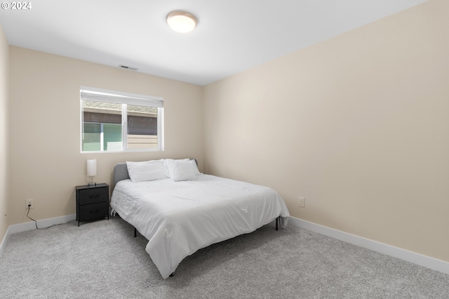 bedroom with light colored carpet