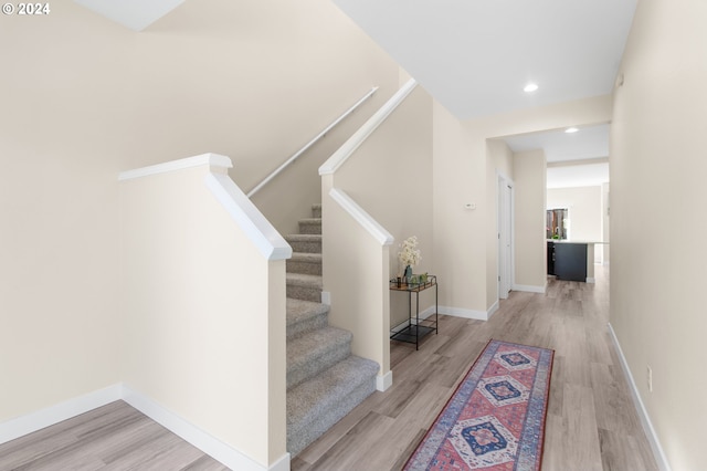 stairway featuring hardwood / wood-style flooring