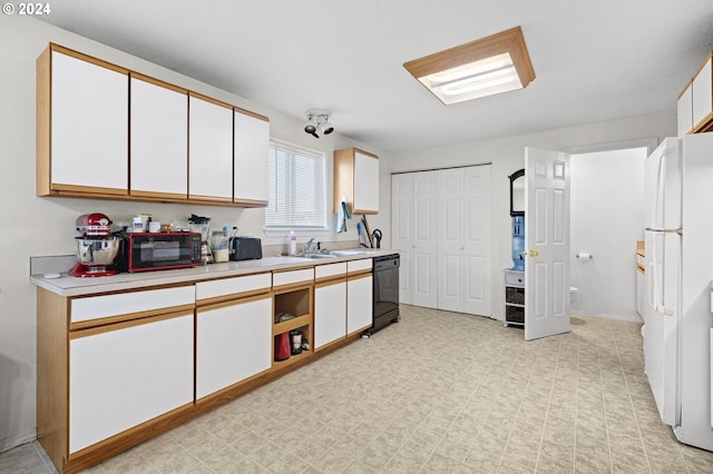 kitchen featuring black appliances and white cabinetry