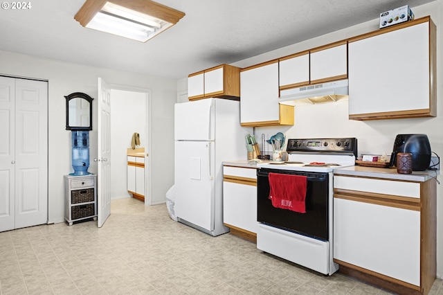 kitchen with white appliances and white cabinetry