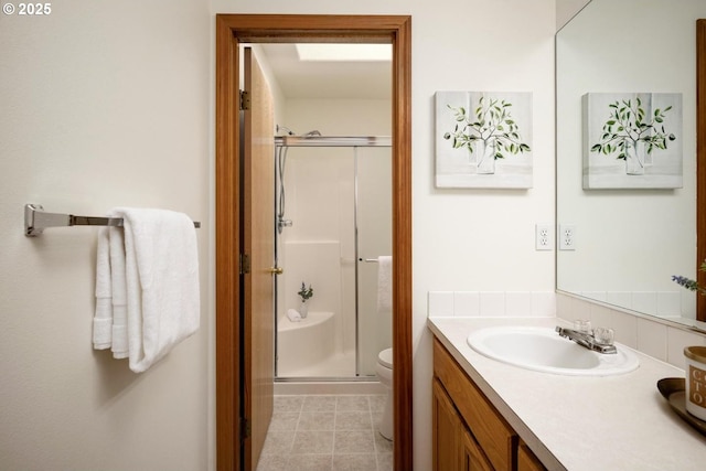 full bath featuring vanity, a shower stall, and toilet