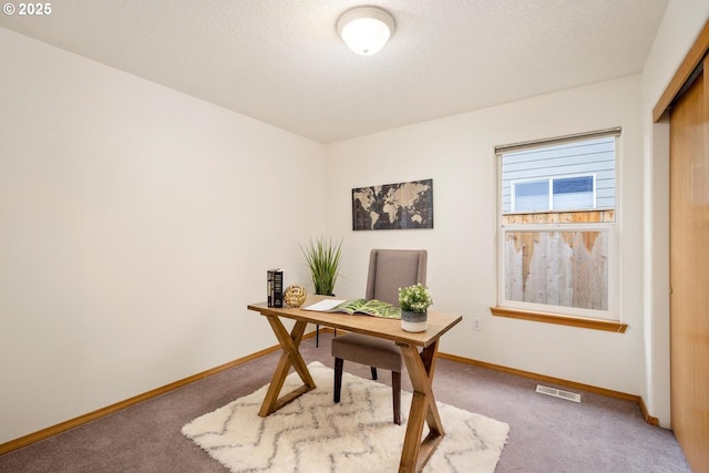 office area featuring visible vents, baseboards, a textured ceiling, and carpet flooring