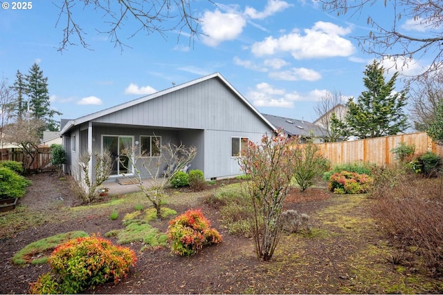 back of house with fence