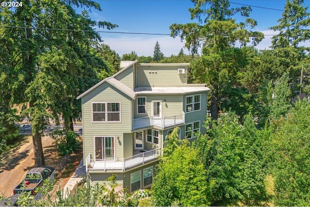 back of property with a balcony