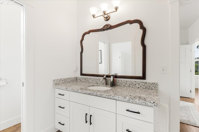 bathroom featuring vanity and hardwood / wood-style flooring