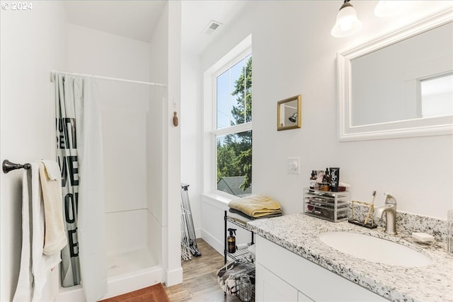 bathroom with vanity, a shower with shower curtain, and hardwood / wood-style floors