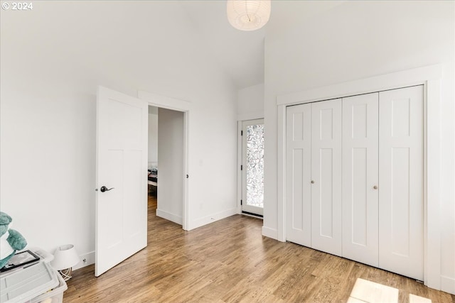 unfurnished bedroom with light hardwood / wood-style flooring and a closet