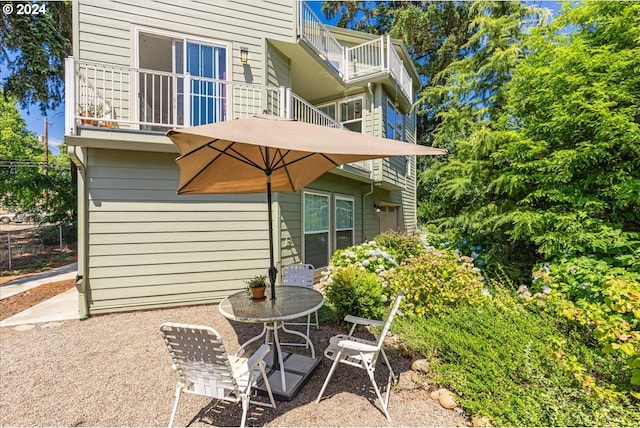 back of property with a balcony and a patio area