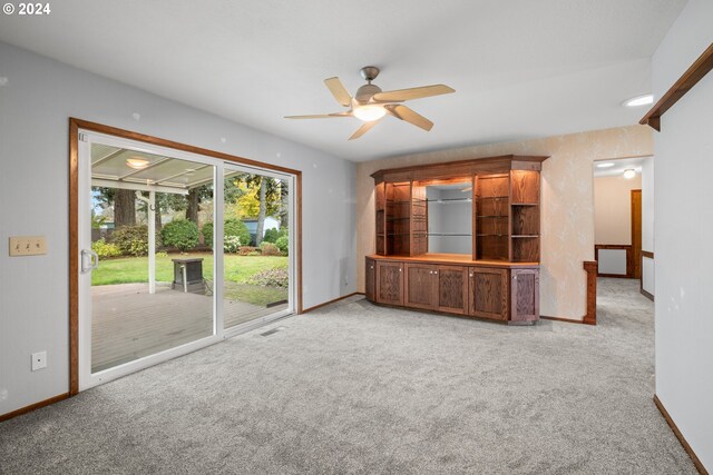 unfurnished living room with ceiling fan and light carpet