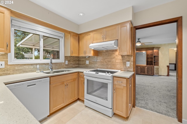 kitchen with ceiling fan, sink, backsplash, white appliances, and light carpet