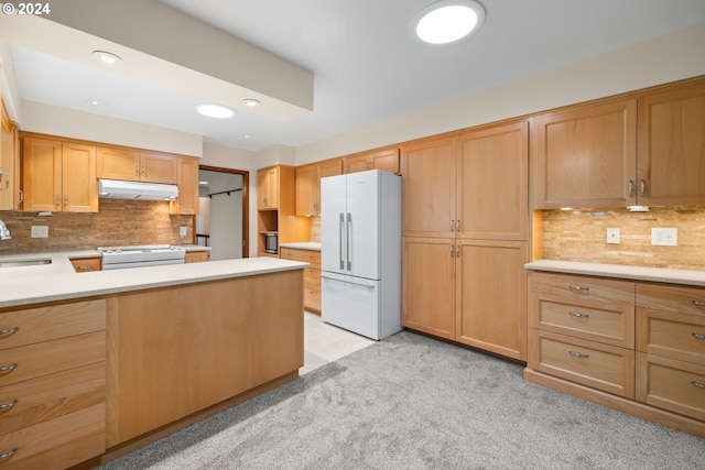 kitchen featuring light colored carpet, white appliances, sink, and tasteful backsplash