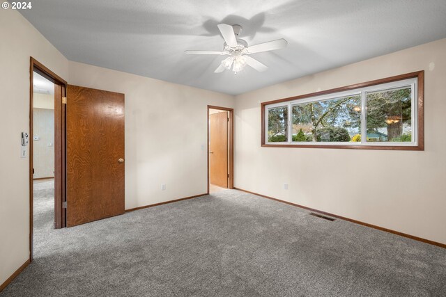 unfurnished bedroom featuring carpet flooring and ceiling fan