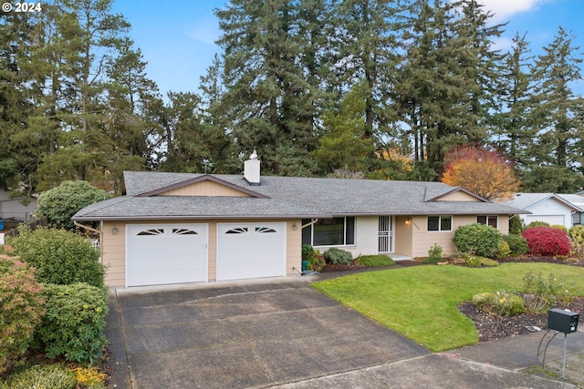 ranch-style home with a front yard and a garage