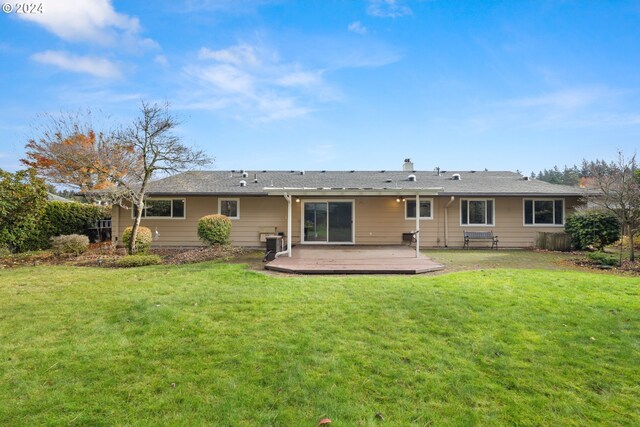 back of house with a wooden deck and a yard