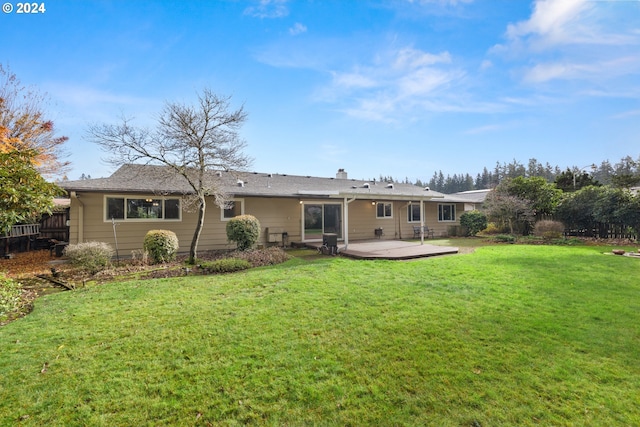 back of house featuring a yard and a patio