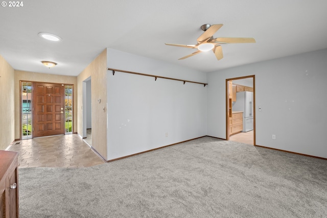 carpeted spare room with ceiling fan