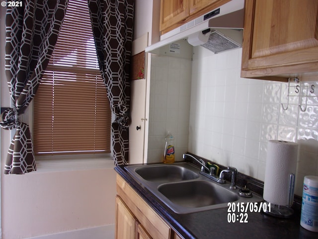 kitchen with tasteful backsplash and sink