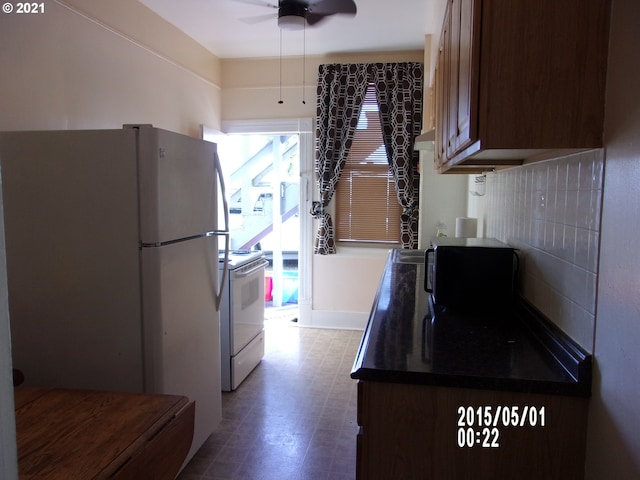 kitchen with ceiling fan, white fridge, and electric range oven