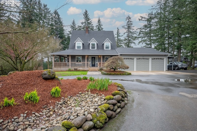 farmhouse-style home featuring crawl space, a garage, a porch, and driveway