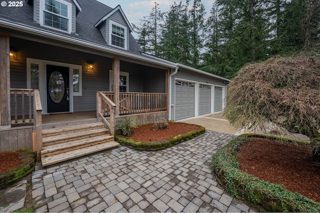 property entrance with a porch, a garage, and roof with shingles