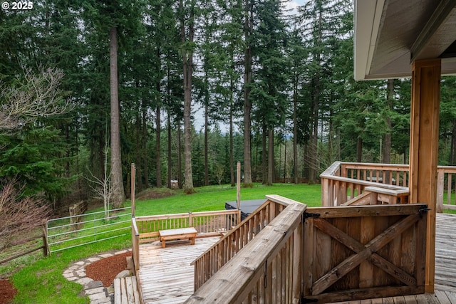 wooden terrace featuring a lawn