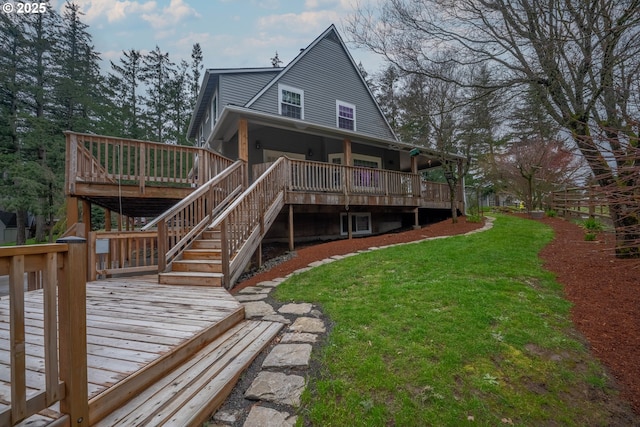 back of house with stairway, a yard, and a wooden deck