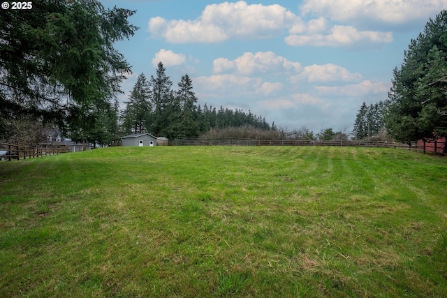 view of yard featuring a rural view and fence